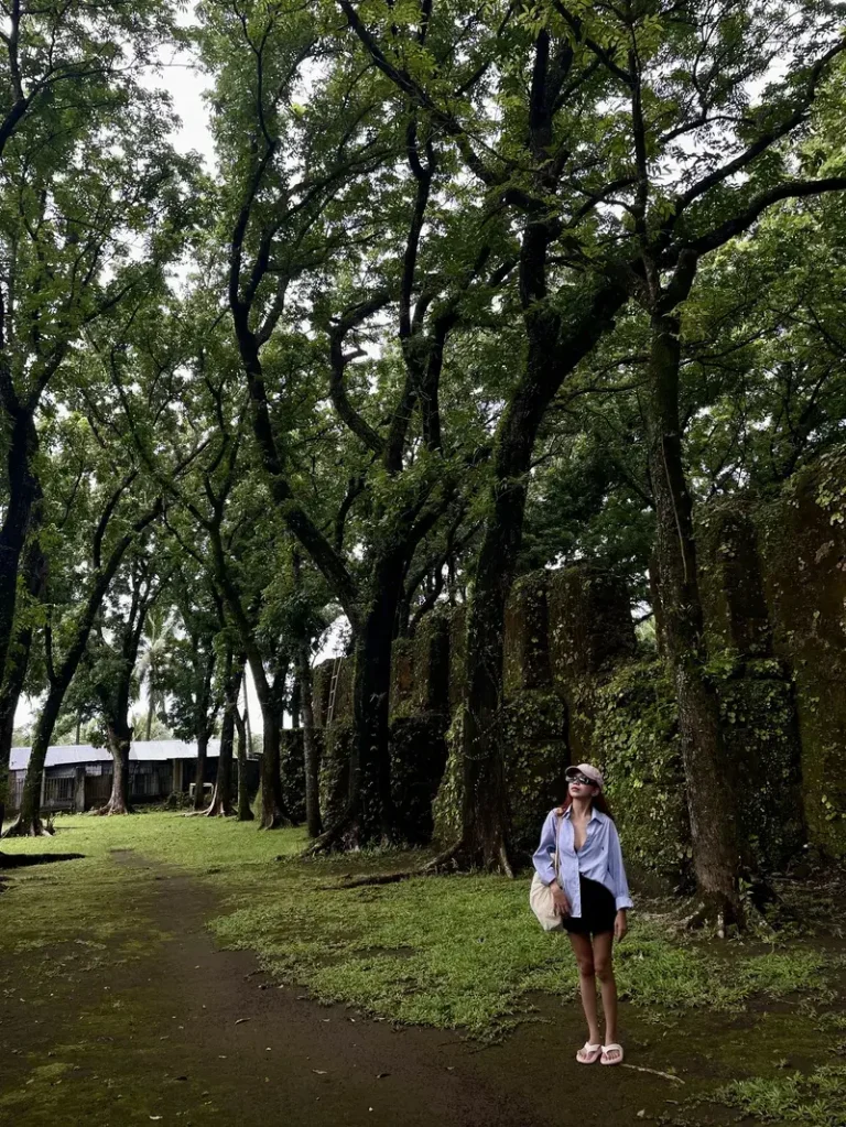 Another pose of my girlfriend looking up at the towering trees while infront of Old Gui-Ob Church Ruin's coral walls