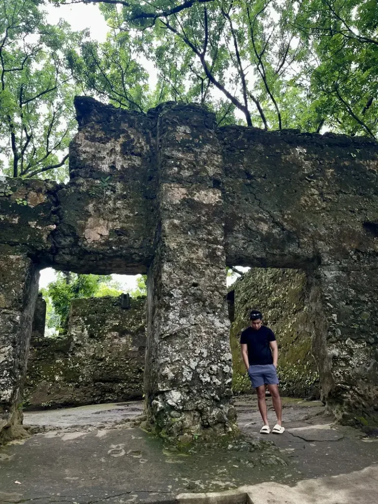Man with a looking down pose beside the old Guiob church ruins in Camiguin Island