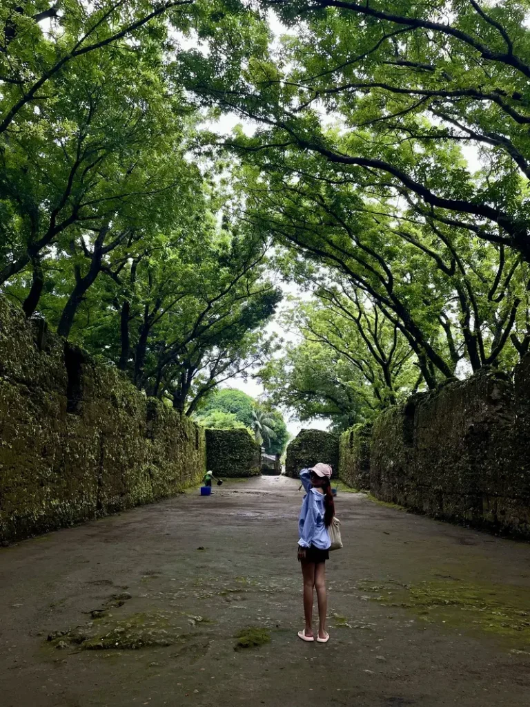 My girlfriend wearing a pink hat with her signature pose in Old Gui-ob Church Ruins in Camiguin