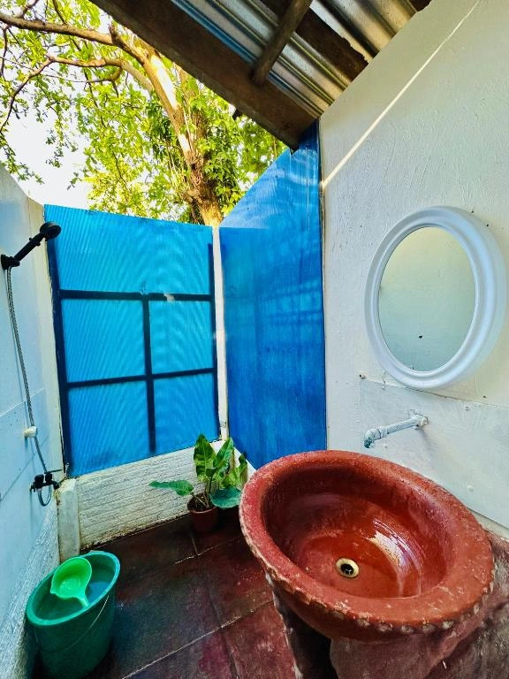Sink and bath area of Playa Del Fuego's budget double room