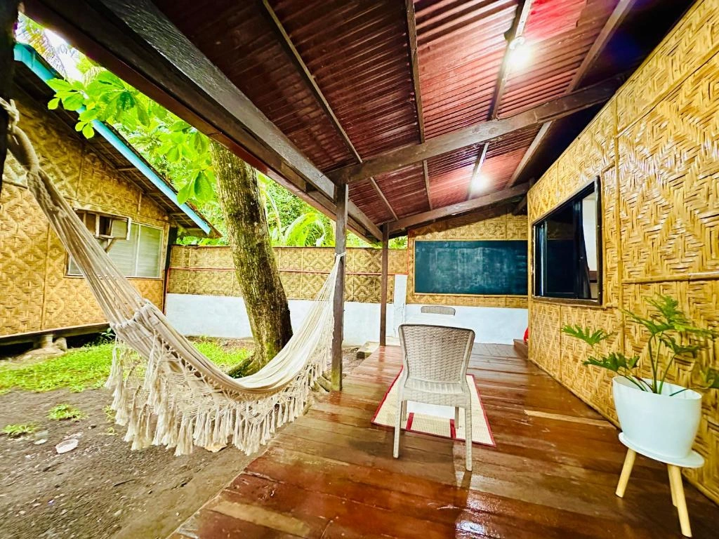 Chill spot of dorm room with a hammock and working tables and chairs