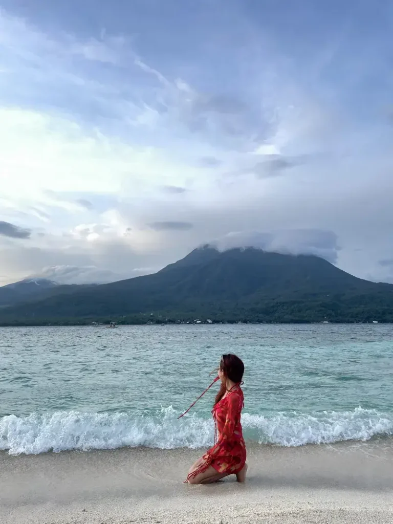 My girlfriend posing on the White Island sand in Camiguin looking at Mount Vulcan